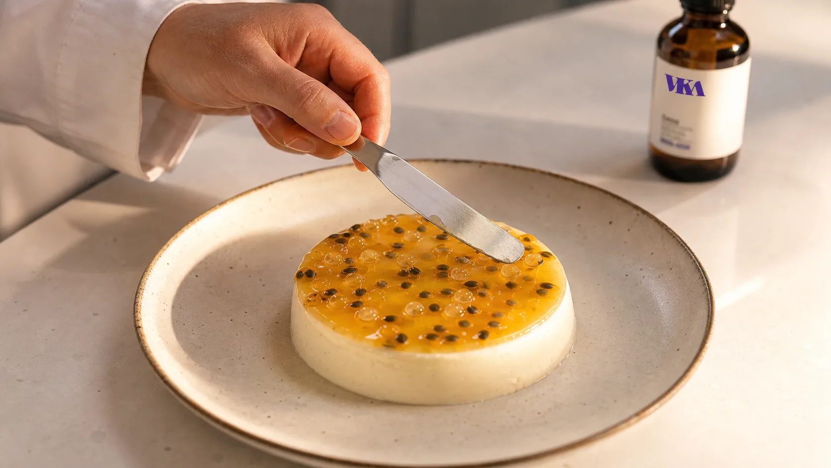 A flavourist finishing panna cotta with a passion fruit and finger lime gel.