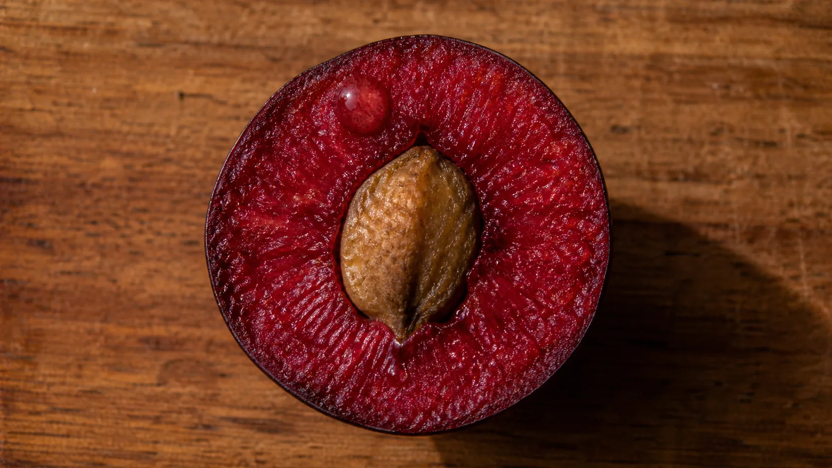 A Davidson plum cut open, the rich crimson flesh of a wild Australian native plum